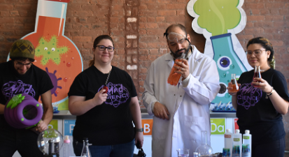 Mad scientist giving a demonstration using beakers, magnets, bottle and lighter